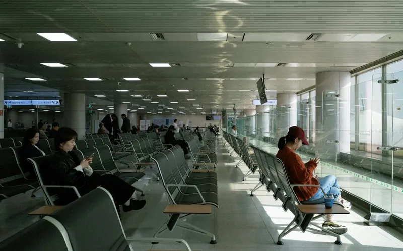 Airport lounge seating by large windows