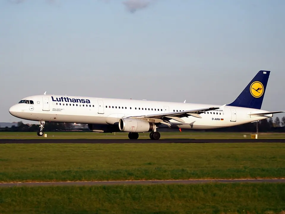 A passenger jet lifting off a runway at sunset