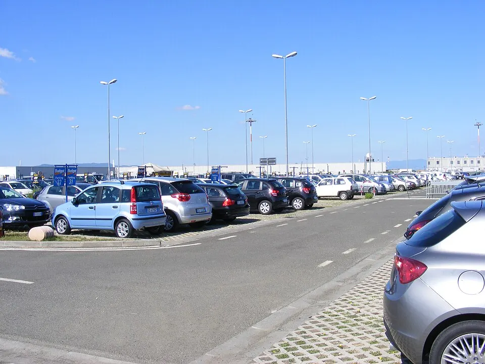 Rental cars parked in rows at an airport car park